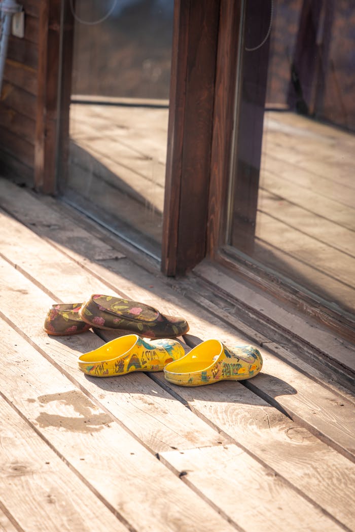creative Colorful slippers on a sunny wooden deck, capturing a warm, homestyle feel in Trabzon, Türkiye.
